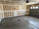 Empty garage with concrete floors and lots of space for vehicles and storage at 8616 Hidden Pines Ave, Las Vegas, NV 89143