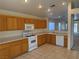 Functional kitchen with ample cabinet space, white appliances, and tile flooring at 8616 Hidden Pines Ave, Las Vegas, NV 89143