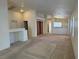 Open-concept living area with carpet flooring, white walls, and ample natural light at 8616 Hidden Pines Ave, Las Vegas, NV 89143