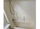 White-tiled shower with bathtub and built-in corner shelves at 8616 Hidden Pines Ave, Las Vegas, NV 89143