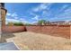 View of the home's backyard showcasing the brick fence and gravel yard at 8626 Anderson Dale Ave, Las Vegas, NV 89178