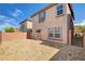Home's backyard with brick fence and gravel plus view of the back of the house at 8626 Anderson Dale Ave, Las Vegas, NV 89178