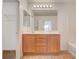 Bathroom featuring a vanity, large mirror with accent lighting and neutral paint at 8626 Anderson Dale Ave, Las Vegas, NV 89178