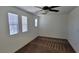 Large bedroom with neutral walls, carpet, ceiling fan, and bright natural light from multiple windows at 8626 Anderson Dale Ave, Las Vegas, NV 89178