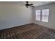 Open bedroom with neutral walls, carpet, ceiling fan, and bright natural light from windows at 8626 Anderson Dale Ave, Las Vegas, NV 89178