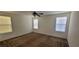 Spacious bedroom with neutral walls, carpet, ceiling fan, and bright natural light from three windows at 8626 Anderson Dale Ave, Las Vegas, NV 89178