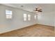 Bright bedroom with neutral carpet, ceiling fan and multiple windows offering natural light at 8626 Anderson Dale Ave, Las Vegas, NV 89178