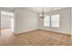 Open dining room with chandelier and a sliding glass door to a patio at 8626 Anderson Dale Ave, Las Vegas, NV 89178