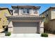 Charming two-story home with a gray garage door, landscaped front yard and visible house number at 8626 Anderson Dale Ave, Las Vegas, NV 89178