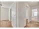 Bright hallway featuring neutral paint, carpet flooring and doorways leading into rooms at 8626 Anderson Dale Ave, Las Vegas, NV 89178