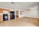 Well-equipped kitchen featuring black appliances, light wood cabinets and an open view to the living room at 8626 Anderson Dale Ave, Las Vegas, NV 89178