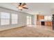 Bright living room featuring neutral carpet, access to backyard, and kitchen area at 8626 Anderson Dale Ave, Las Vegas, NV 89178