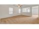 Spacious carpeted living room with a ceiling fan and natural light from a large window at 8626 Anderson Dale Ave, Las Vegas, NV 89178