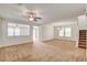Spacious carpeted living room with a ceiling fan and natural light from a large window at 8626 Anderson Dale Ave, Las Vegas, NV 89178