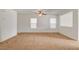 Bright, open living room featuring neutral carpet, ceiling fan and plenty of natural light at 8626 Anderson Dale Ave, Las Vegas, NV 89178
