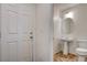 Charming powder room with a pedestal sink and toilet, located near the home's entrance at 8626 Anderson Dale Ave, Las Vegas, NV 89178