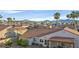 A real estate aerial shot showcasing a house with desert landscaping and a community with mountain views at 904 Rhyolite Ter, Henderson, NV 89011