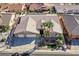 Stunning aerial view of the home showcasing its desert landscaping, three-car garage, and immaculate desert landscaping at 904 Rhyolite Ter, Henderson, NV 89011