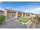 Lovely backyard with a covered patio, artificial grass, desert landscaping, and an inviting pool area at 904 Rhyolite Ter, Henderson, NV 89011
