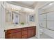 Bathroom featuring double sinks, a large mirror and shower over tub at 904 Rhyolite Ter, Henderson, NV 89011