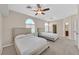 Inviting bedroom featuring arched windows, ceiling fan, and neutral color palette at 904 Rhyolite Ter, Henderson, NV 89011