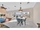 Bright dining area with views of the backyard and the pool in an open concept layout with modern chandelier at 904 Rhyolite Ter, Henderson, NV 89011