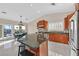 Bright kitchen with granite countertops, stainless steel appliances, and views of the outdoor dining area at 904 Rhyolite Ter, Henderson, NV 89011