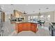 Spacious kitchen featuring a center island, stainless steel appliances, and a stone accent wall with fireplace at 904 Rhyolite Ter, Henderson, NV 89011