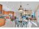 Open-concept layout with a kitchen, dining area, and a living space featuring a stone accent wall and fireplace at 904 Rhyolite Ter, Henderson, NV 89011