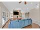 Spacious living room featuring hardwood floors, neutral walls, stone fireplace, stylish furniture, and bright lighting at 904 Rhyolite Ter, Henderson, NV 89011