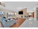 Spacious living room featuring hardwood floors, neutral walls, stone fireplace, stylish furniture, and bright lighting at 904 Rhyolite Ter, Henderson, NV 89011