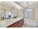 Bright main bathroom features a double vanity, jetted tub, and separate shower at 904 Rhyolite Ter, Henderson, NV 89011