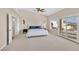 Well-lit main bedroom with carpet, horse artwork, and an exterior view with access to the pool at 904 Rhyolite Ter, Henderson, NV 89011