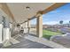 Spacious covered patio with tile flooring, elegant columns, and comfortable seating area with neighborhood views at 904 Rhyolite Ter, Henderson, NV 89011