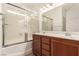 Bathroom features a double vanity with wood cabinets and shower with sliding glass doors at 9773 Bedstraw St, Las Vegas, NV 89178