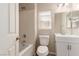 Bright bathroom featuring a toilet, vanity, and combined tub and shower with a window at 9773 Bedstraw St, Las Vegas, NV 89178