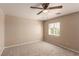 Bedroom with ceiling fan, neutral carpeting, and window with blinds at 9773 Bedstraw St, Las Vegas, NV 89178