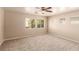 Bedroom boasts neutral paint, carpeting, ceiling fan, and multiple windows at 9773 Bedstraw St, Las Vegas, NV 89178