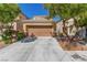 Charming beige home with a two-car garage, desert landscaping, and a concrete driveway at 9773 Bedstraw St, Las Vegas, NV 89178