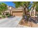 Charming home with a two-car garage, desert landscaping, and a concrete driveway at 9773 Bedstraw St, Las Vegas, NV 89178