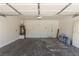 An empty two car garage featuring painted walls and sealed concrete floors at 9773 Bedstraw St, Las Vegas, NV 89178