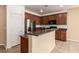Modern kitchen features wood cabinets, tile flooring, stainless steel appliances and island at 9773 Bedstraw St, Las Vegas, NV 89178