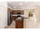 Bright kitchen with stainless steel appliances, dark cabinets, and breakfast bar at 9773 Bedstraw St, Las Vegas, NV 89178