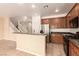Open kitchen with stainless steel appliances, dark cabinets, and tile flooring at 9773 Bedstraw St, Las Vegas, NV 89178