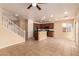 Open-concept living room with tile flooring, staircase, and a view of the kitchen at 9773 Bedstraw St, Las Vegas, NV 89178