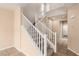 A carpeted staircase featuring white risers and wooden handrails ascending to the upper level at 9773 Bedstraw St, Las Vegas, NV 89178