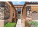 Close up of front door with a stone veneer and desert landscaping at 9812 Turtle Walk Ave, Las Vegas, NV 89149