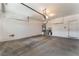 Spacious garage featuring a concrete floor, water heater, overhead lighting, and door to the side yard at 9812 Turtle Walk Ave, Las Vegas, NV 89149