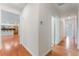 A view of the house hallway, which has hardwood floors and is painted in neutral colors, creating a cohesive design at 9812 Turtle Walk Ave, Las Vegas, NV 89149