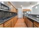Bright kitchen featuring wooden cabinets, granite countertops and stainless steel appliances, creating a functional cooking space at 9812 Turtle Walk Ave, Las Vegas, NV 89149